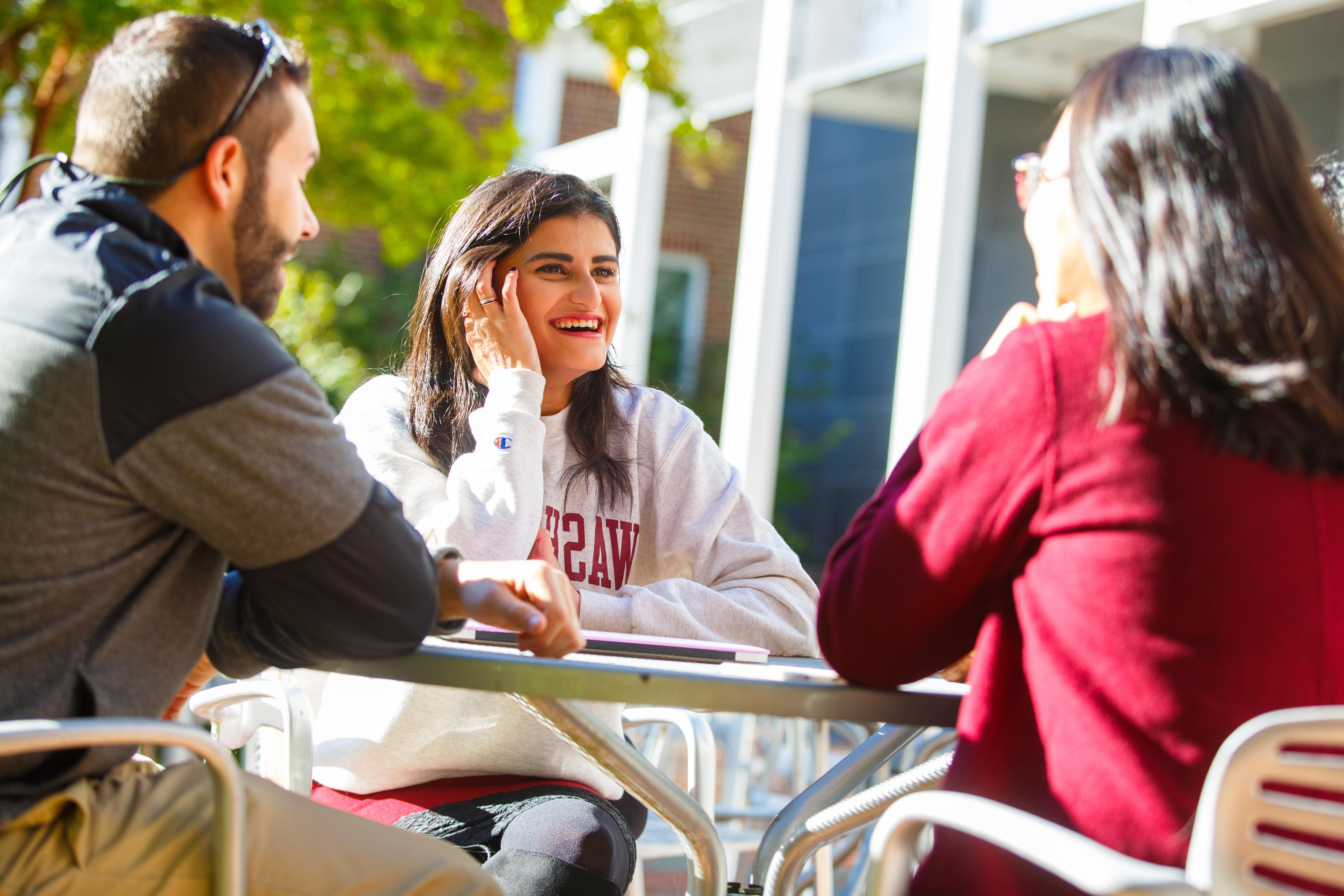 students sitting outside hodson smiling