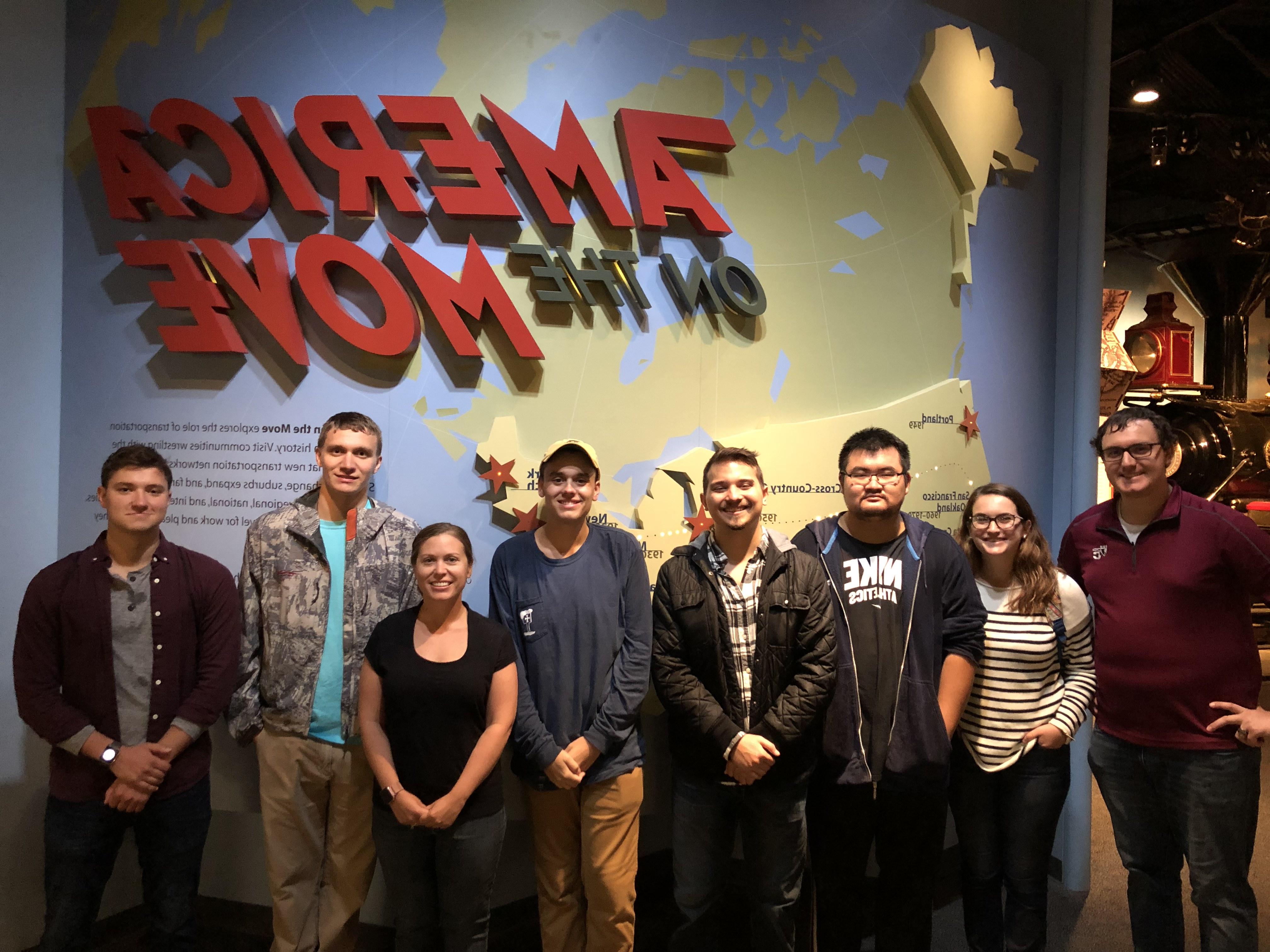 Group in front of America on the Move sign